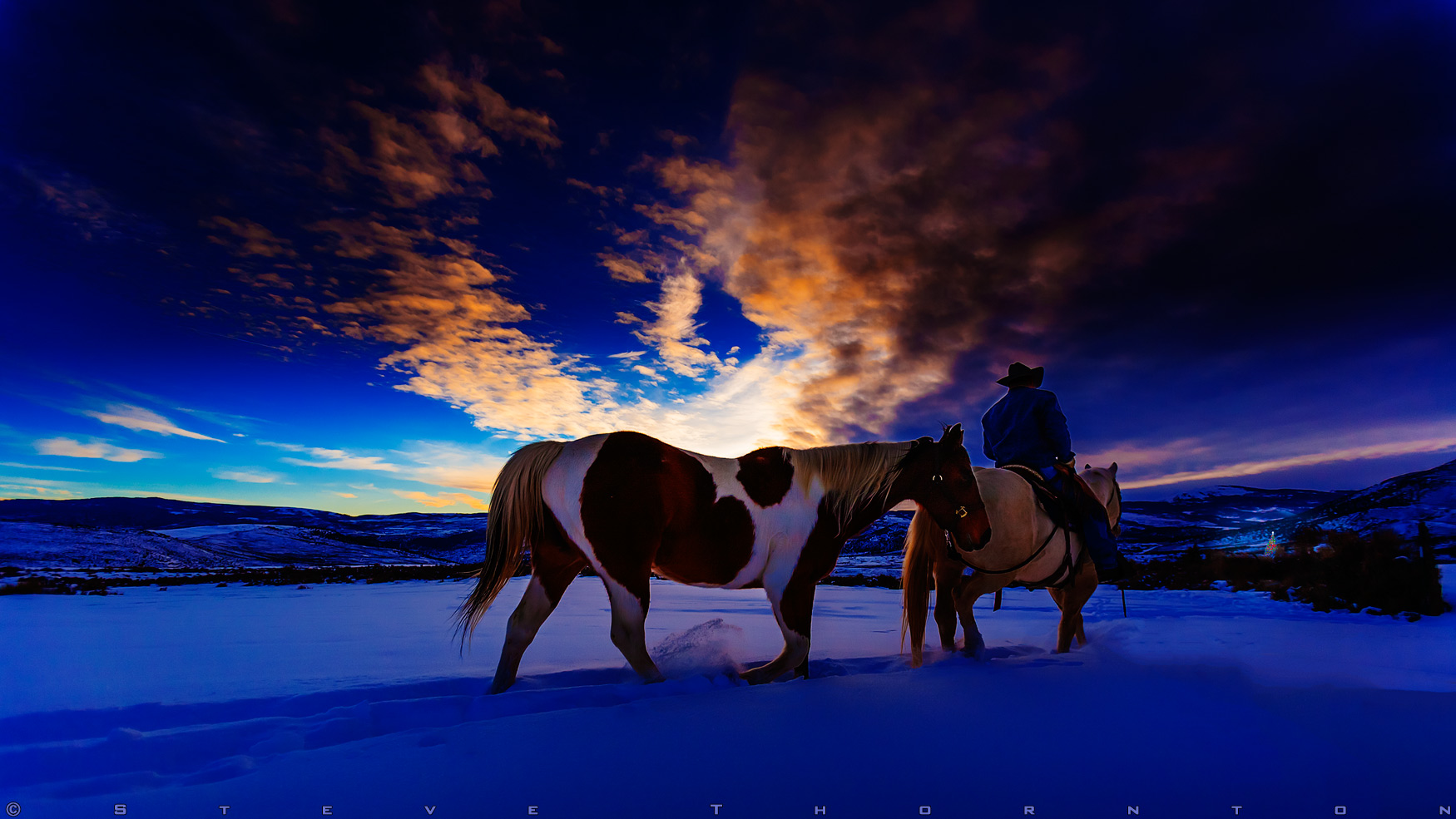 This cowboy image was shot in Colorado on a cold day just after sunset. The cowboy (Tom Calvin) is heading towards the brightly lit tree in the distance. We both rode out to the location to get clean & untracked snow. There were 2 small animal tracks that I removed in Photoshop.